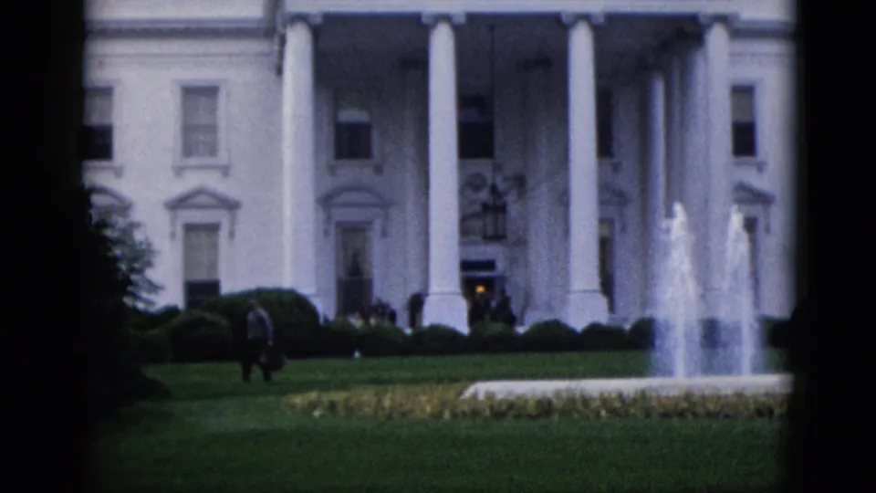White House North Portico with fountain in full spray and at least one visitor figure on the North Lawn, filmed on 8mm circa early 1950s, Washington DC.