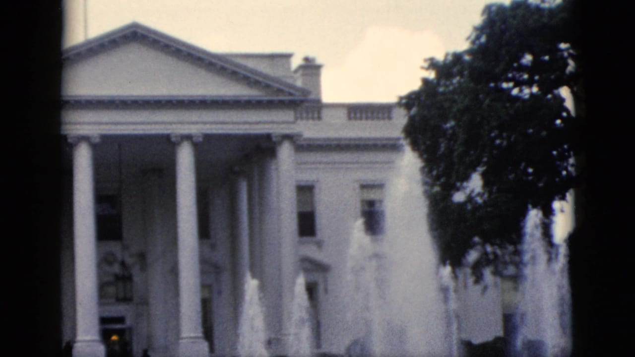 8mm home movie frame, c.1952, closer framing of White House north portico with active fountain jets and small figure near entrance.
