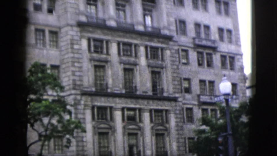 Lower floors of a large neoclassical stone building showing pilasters, rusticated stone, and cornice details, Washington DC, circa 1952.