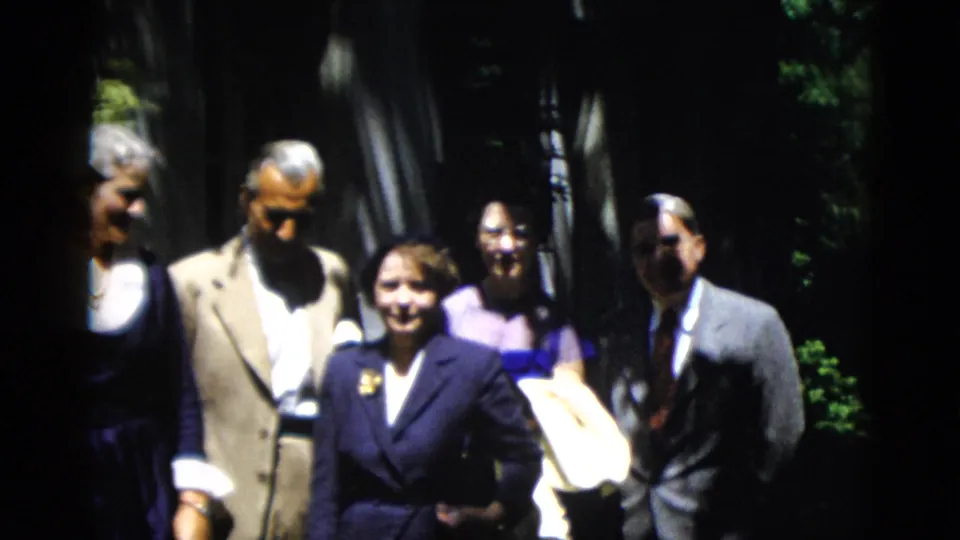 1952 Washington DC home-movie frame with a formally dressed group standing close together outdoors.