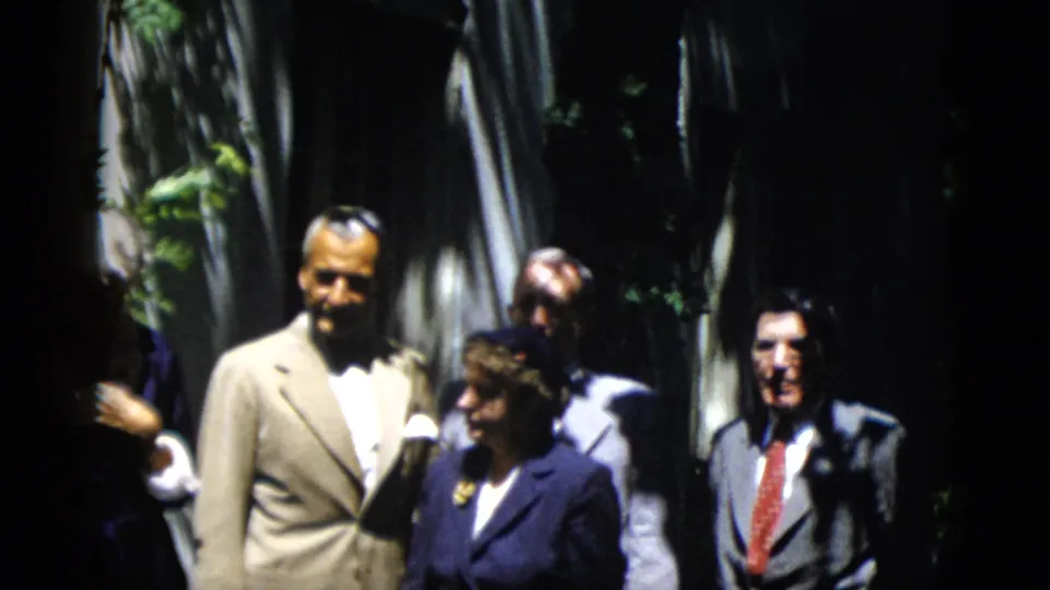 The 1952 Washington, DC footage shows adults in formal clothing standing in shade, with a man in a light suit near the front.