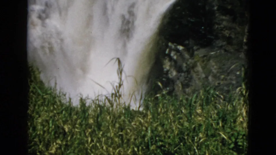8mm home movie, circa 1952, Quebec Canada — waterfall over dark rock with tall green grasses prominent in right foreground