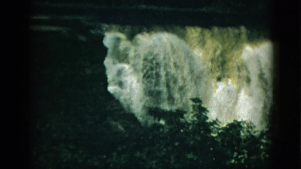 8mm color film, likely 1952 Quebec, showing a steep waterfall cascade with prominent white spray and dark forest visible at lower right.