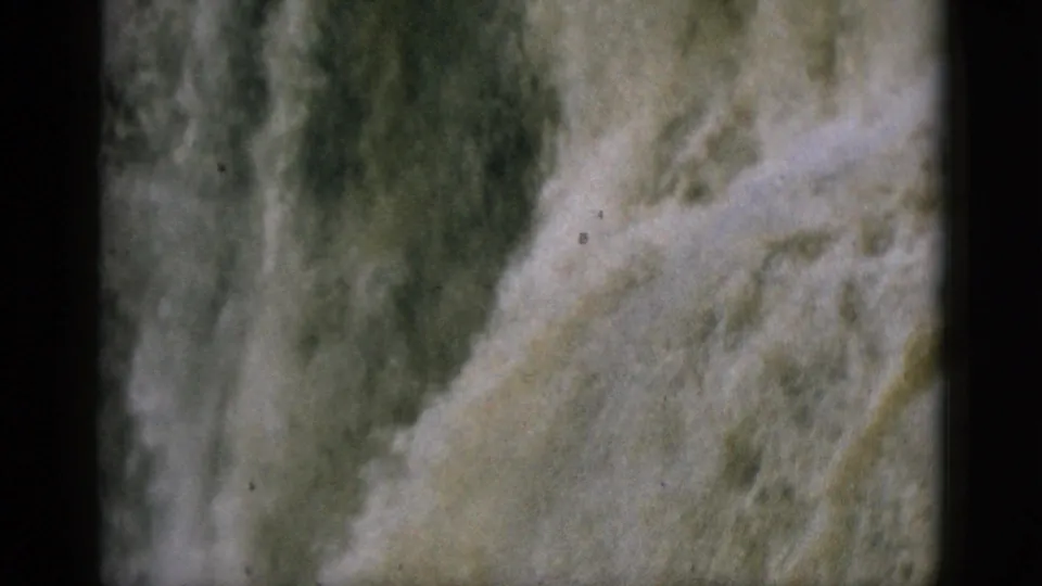 Continuous shot of a powerful waterfall cascade on 8mm home movie film, Quebec circa 1952, showing turbulent water across the full frame