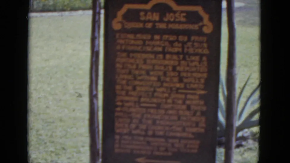 Sign header "San José / Queen of the Missions" in orange on brown board; wooden post and agave plant visible; 8mm color, circa 1952.