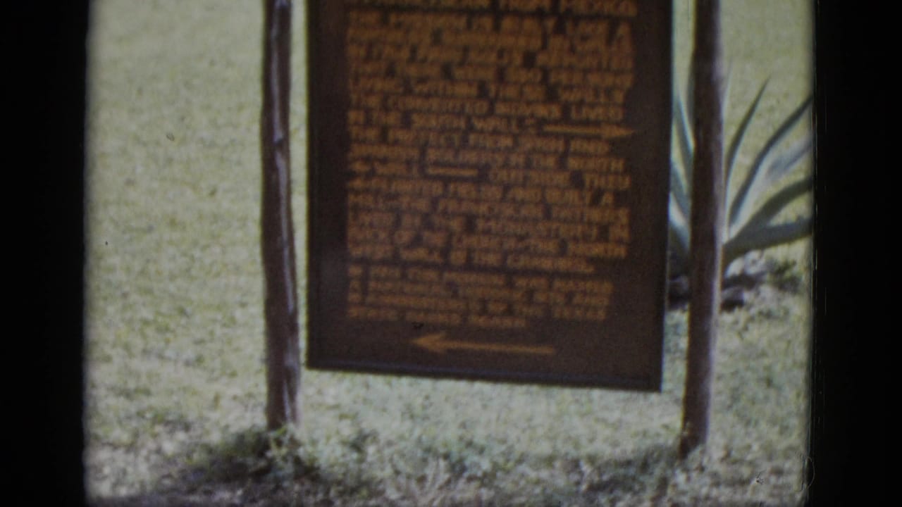 8mm frame of the San José Mission historical marker with founding text referencing 1720, flanked by agave plants and lawn, circa 1952.
