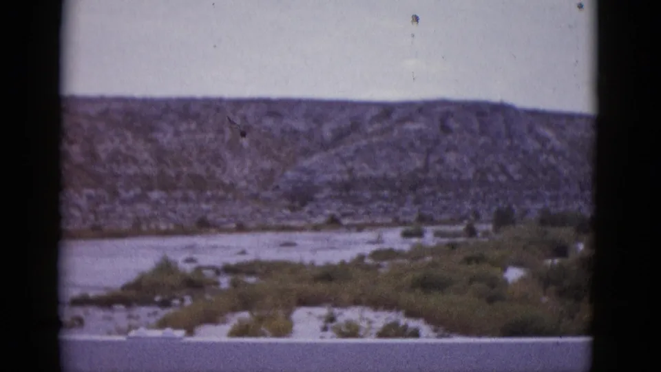 Arid Texas mountain landscape above dry wash, from an 8mm home movie reel circa 1952.