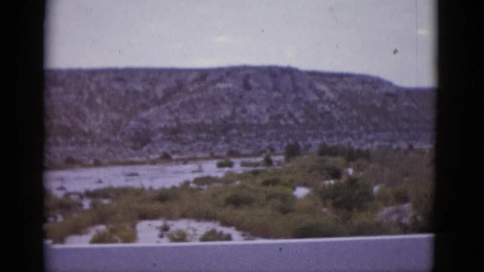 Wide arid Texas mountain and dry wash landscape, 8mm home movie c. 1952.