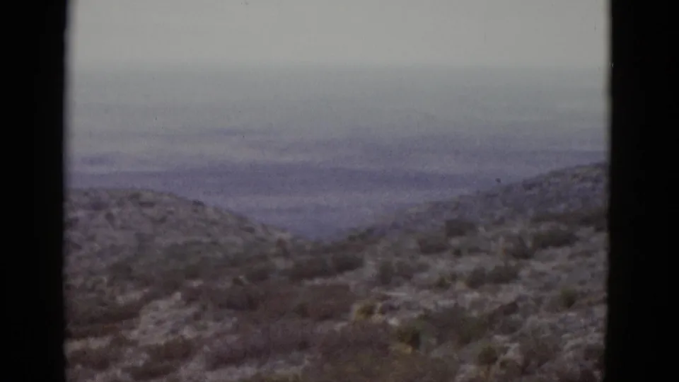 Arid desert hill covered in sparse low scrub, photographed on 8mm color film consistent with a Utah landscape circa 1952.