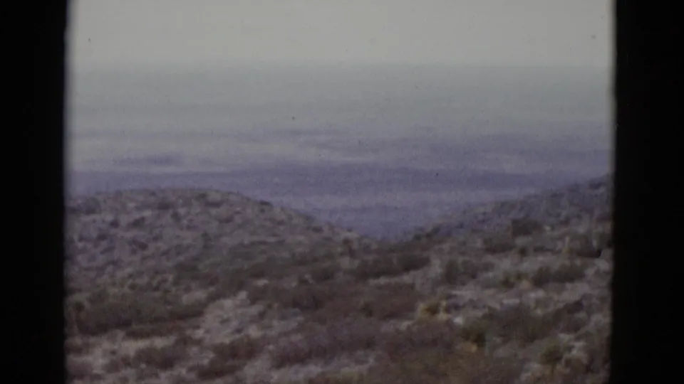 Desert hill and arid scrubland consistent with the Utah landscape, captured on 8mm color film circa 1952; composition nearly identical to opening frame.