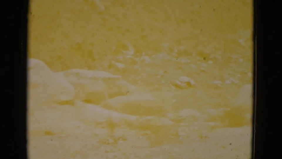 Strongly yellow-shifted 8mm frame, consistent with 1952 Utah desert; pale cream boulder forms visible through severe chemical dye fading.