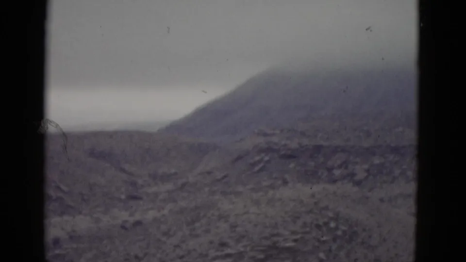 Continued view of a barren mountain and arid Utah terrain from a 1952 8mm home movie; film artifacts, dust specks, and color fade are prominent throughout.