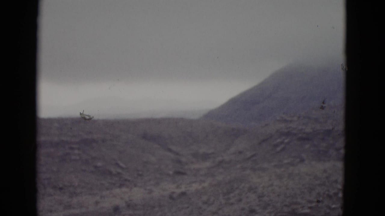 Arid Utah desert ridgeline circa 1952; a small unidentified object appears at the horizon, possibly a distant vehicle or post.