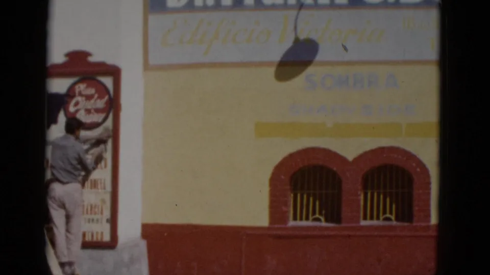 Building facade with 'Edificio Victoria' and 'SOMBRA' section label prominent; worker on ladder at left edge; likely entertainment venue, northern Mexico, circa 1952.