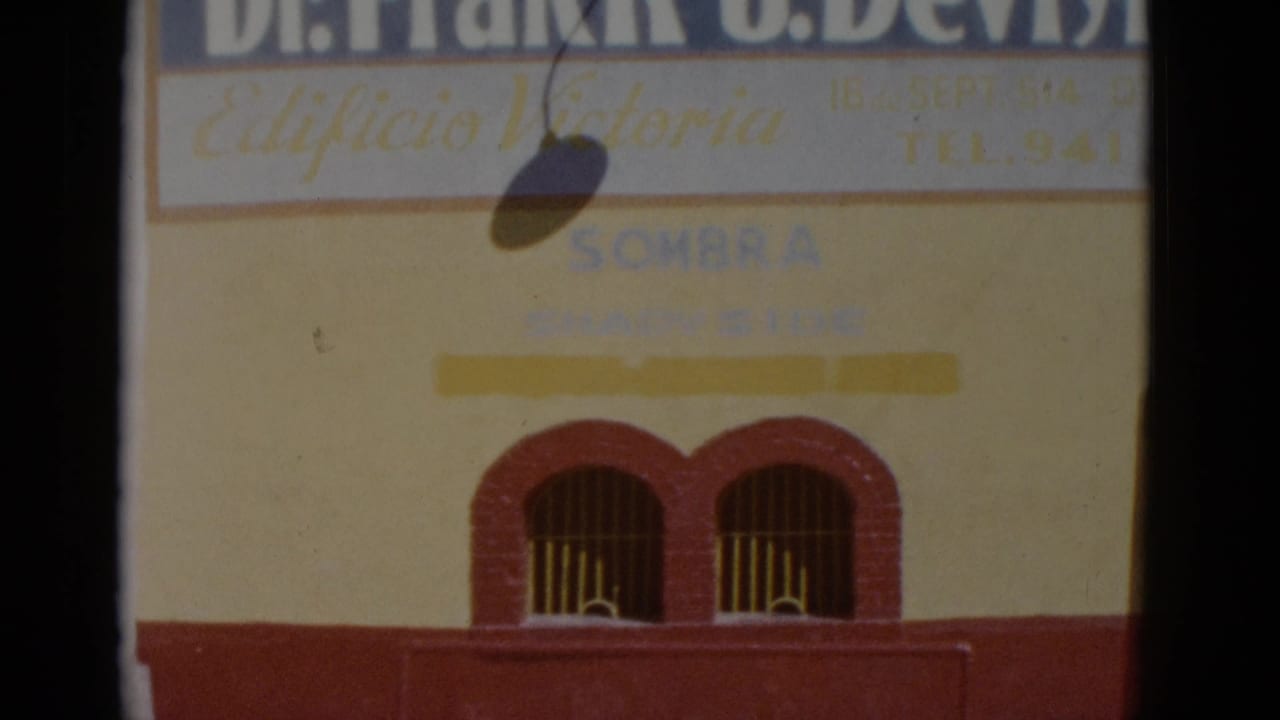 Yellow-and-red commercial building facade in Baja California, Mexico, circa 1952, showing 'Dr. Frank J. Devlyn,' 'Edificio Victoria,' and 'SOMBRA' painted signage.