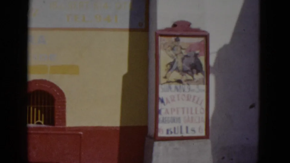 Bullfight promotion poster in Baja California, circa 1952, showing a matador-and-bull illustration and printed names including Capetillo and Gregorio Garcia; plain wall at right.