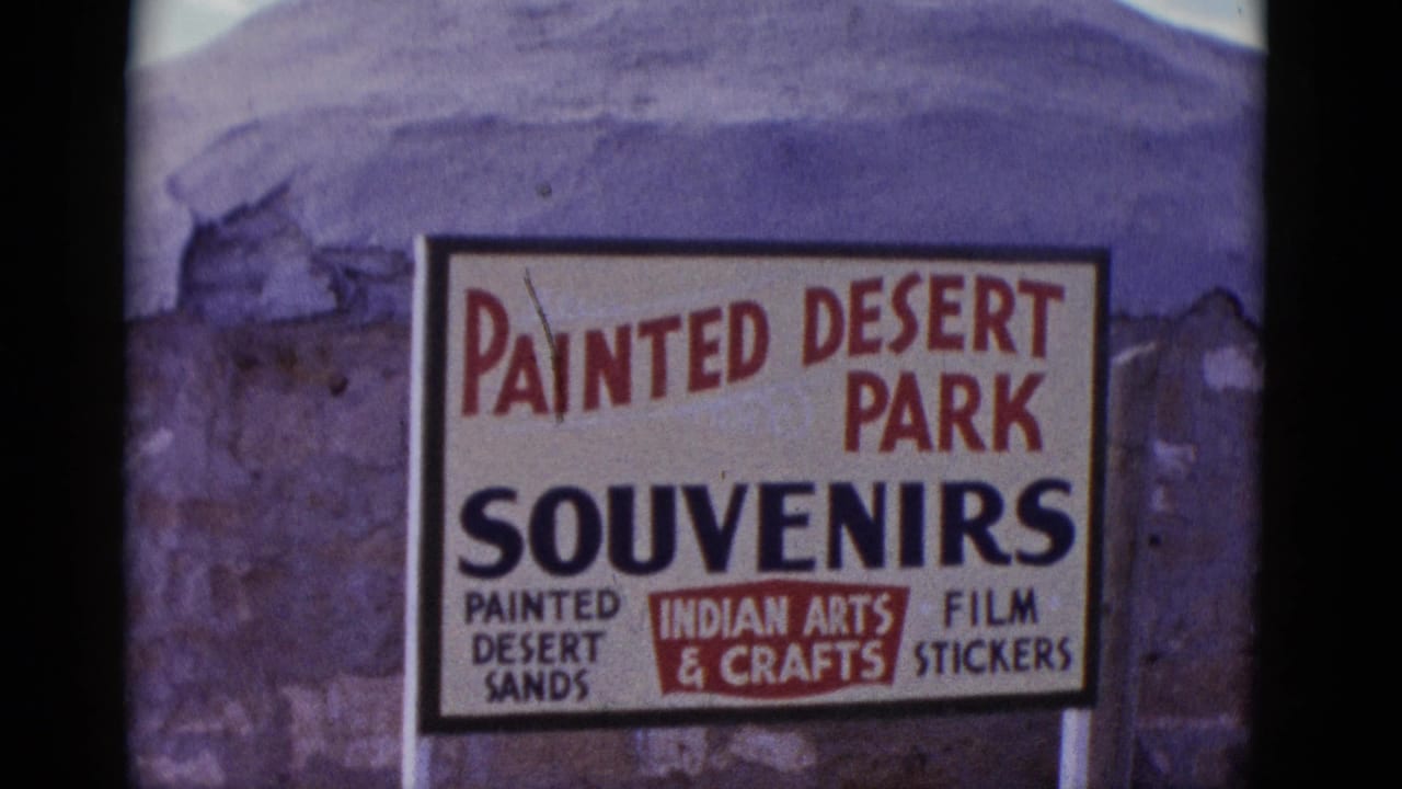 Painted Desert Park Souvenirs sign on a textured wall.