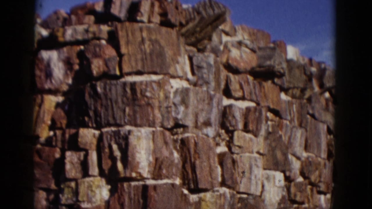 Stone wall corner with rough stacked stones and dark frame edges.