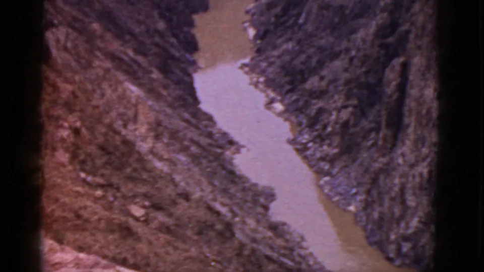 Final contact-sheet frame shows a pale muddy river segment bordered by steep rocky terrain in the 1952 Arizona travel footage.