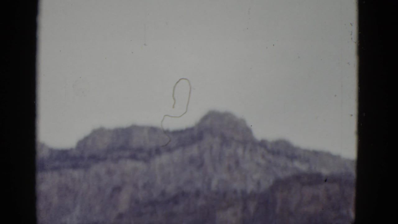 Soft mountain ridge seen through dark 8mm frame borders.