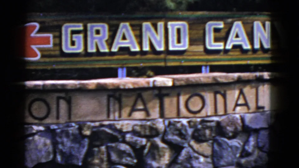 1952 Arizona frame with the Grand Canyon sign cropped across the top and National Park lettering visible on the stone base below.