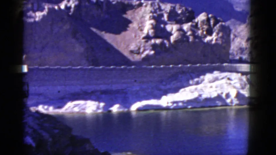 Wide California reservoir and mountain view with a dam wall visible at the edge of the frame, dated 1952 by metadata.