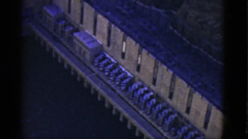 1952 California 8mm frame with a closer high-angle look at repeated structures running beside a dark channel.