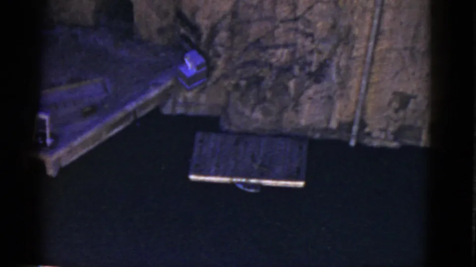 The final frame of the 1952 California clip shows the display platform partly out of view, a textured backdrop, and a separate rectangular surface below.