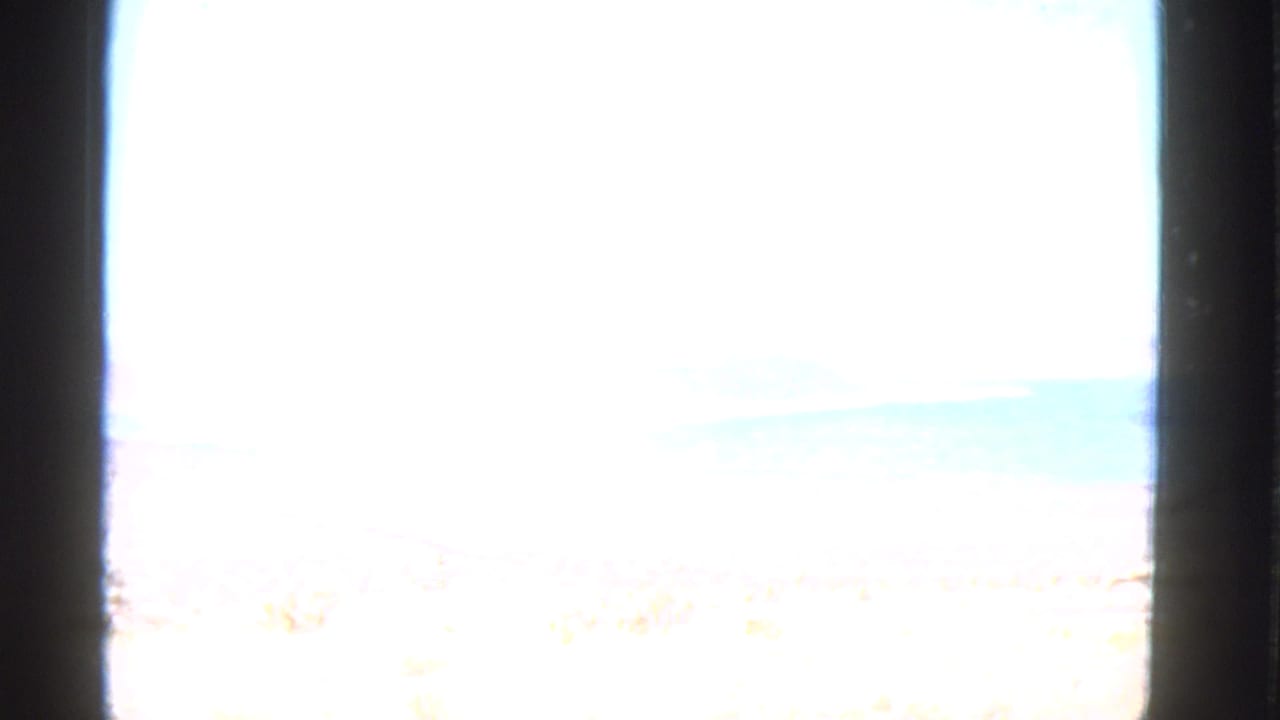Bright overexposed view through a dark car window or interior frame.
