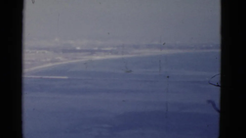 California 1952 8mm travel shot with ocean, hazy horizon, faint shore, and dark window-like framing.