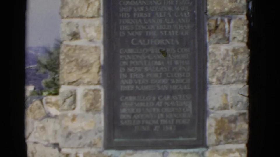 A soft 8mm view shows the lower Cabrillo plaque, stone masonry, and contact-sheet banding.
