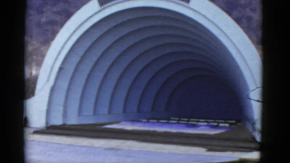 1952 California 8mm frame showing the empty arched amphitheater shell and stage under natural daylight.