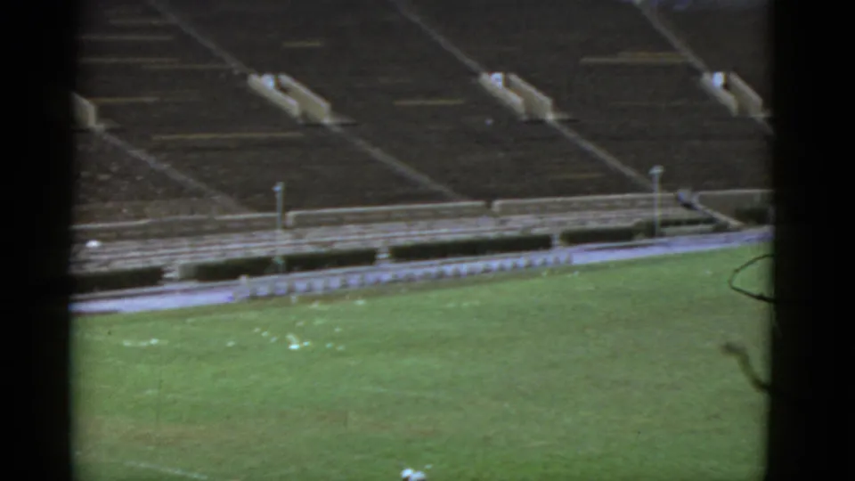 Final 1952 California frame showing an empty football field and distant bleachers, with faded 8mm color and visible film borders.