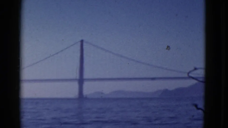 1952 San Francisco 8mm frame showing a likely Golden Gate Bridge view across water with hills in the distance.
