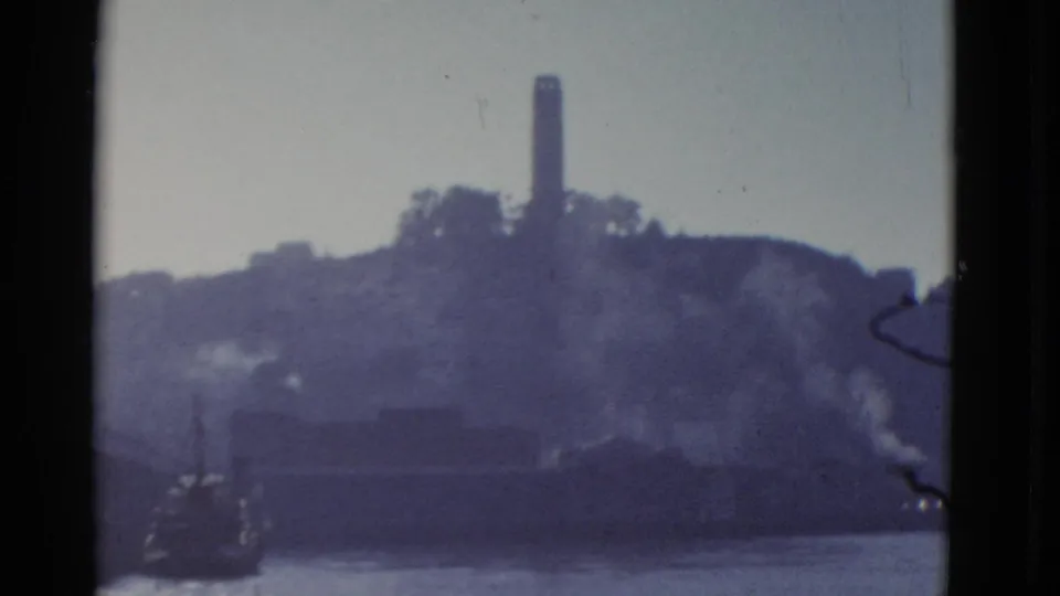1952 San Francisco frame showing Alcatraz Island, bay water, and boat-edge framing in soft blue 8mm color.