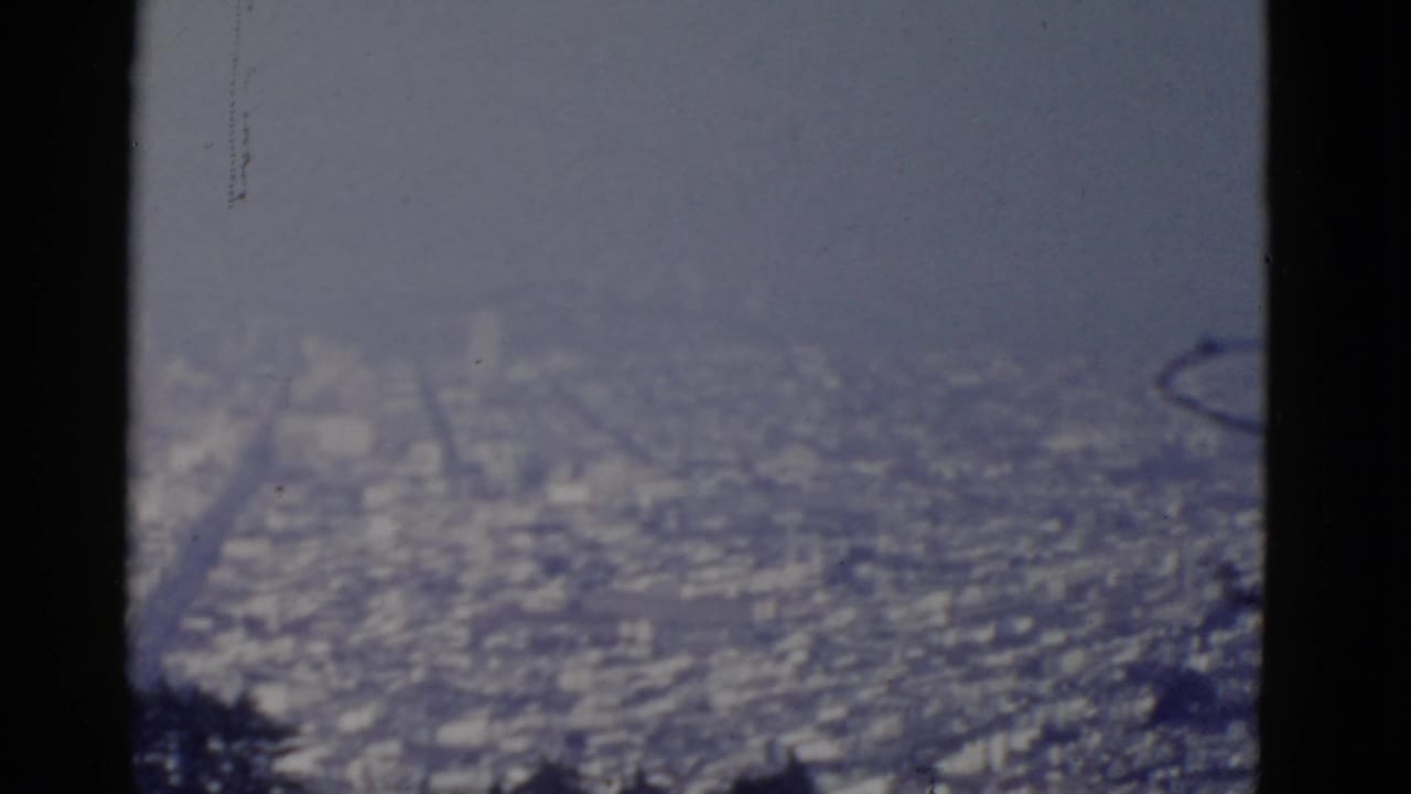 Soft, hazy 8mm view of the San Francisco coast from the Cliff House area, with the shoreline blurred by distance and exposure.