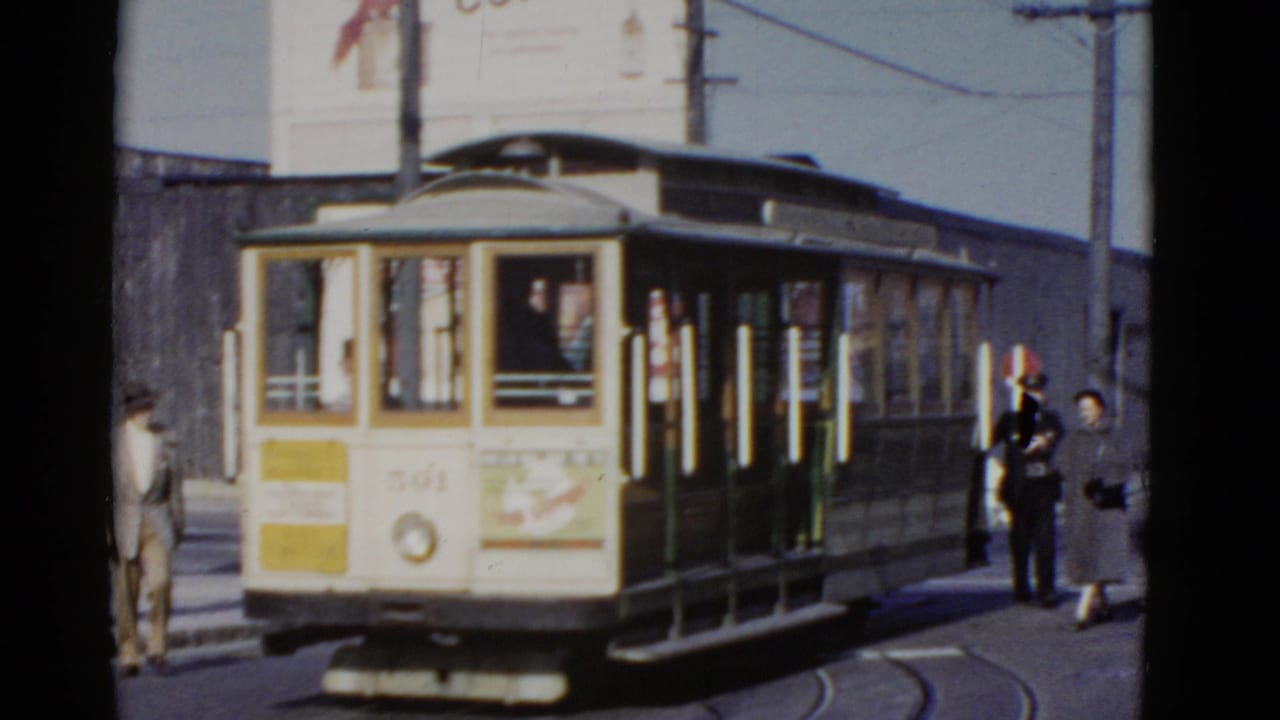 Cable car 501 at a stop with several people standing beside it.