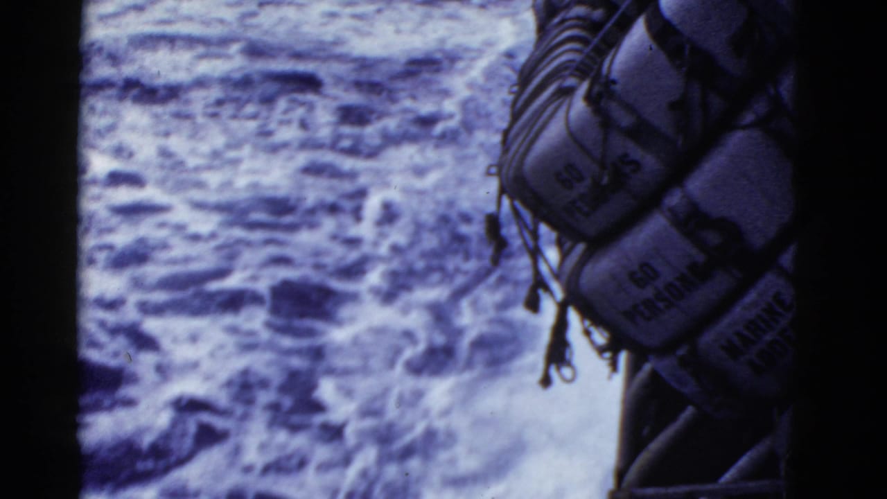 1950s 8mm shipboard view near San Francisco showing rough water and a hanging life raft marked for multiple persons.