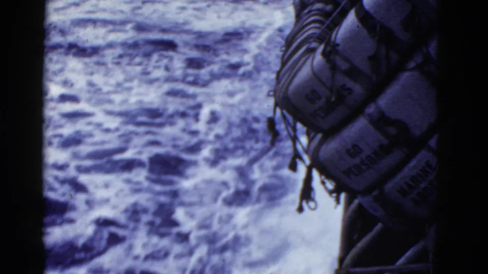 1950s 8mm shipboard view near San Francisco showing rough water and a hanging life raft marked for multiple persons.