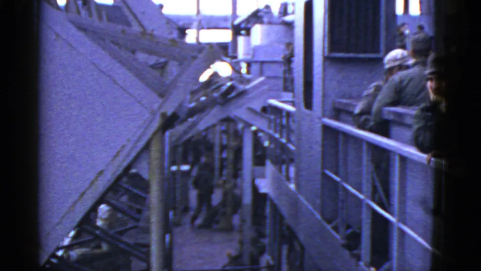 1950s 8mm naval ship deck near San Francisco showing sailors, railings, stairways, and upper-deck movement.