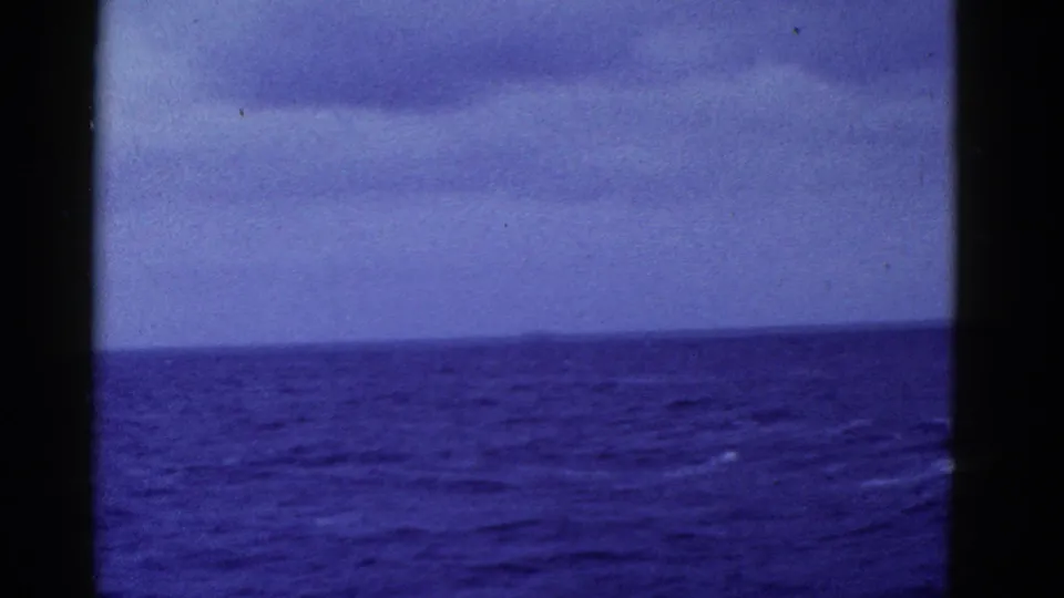 1952 8mm home-movie view of open sea near San Francisco, with a slightly tilted horizon, blue color shift, and dark gate borders.