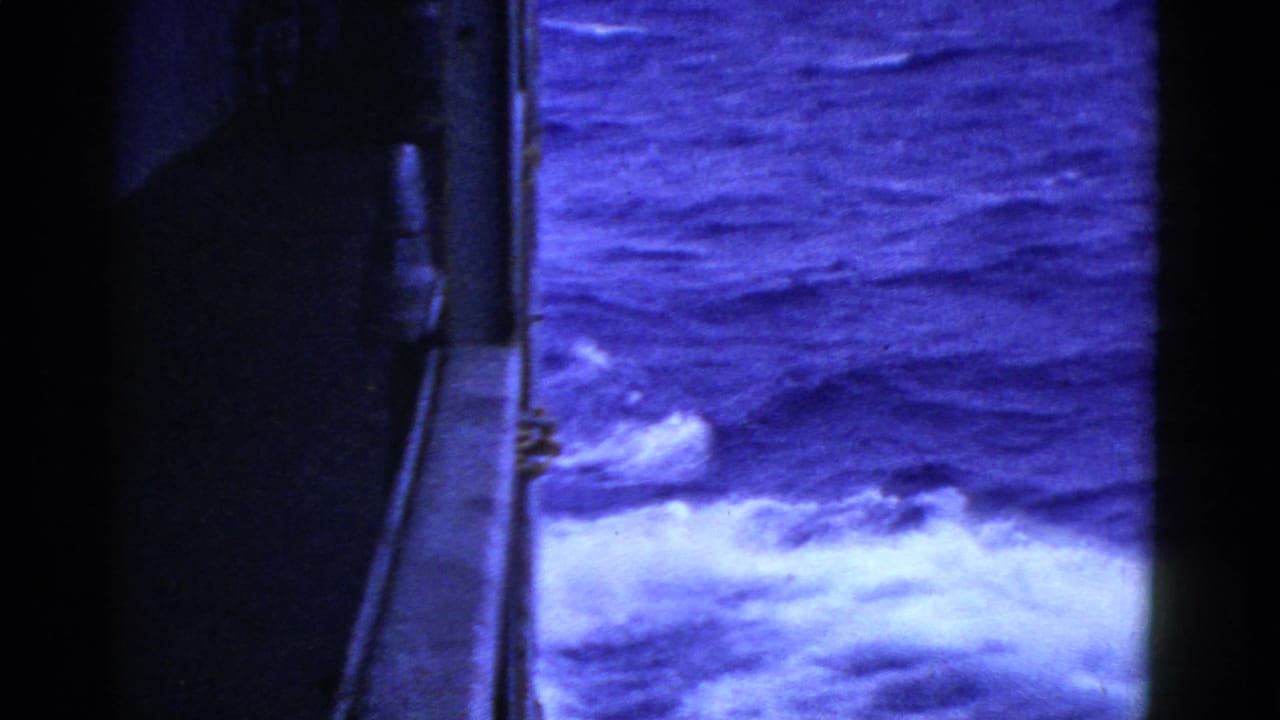 A blue-tinted 1952 shipboard view near San Francisco shows the vessel edge and foamy water moving alongside.