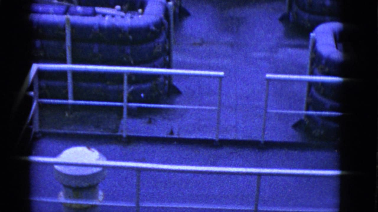 1952 San Francisco footage appears to show uniformed men resting below railings and pipes in a sparse camp or transport interior.