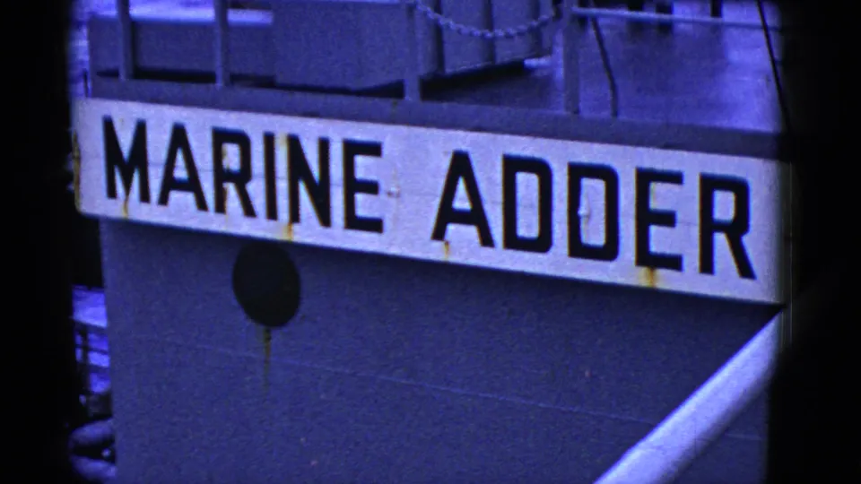 The Marine Adder name panel remains prominent, with railings, hull details, and a diagonal pipe or boom visible.