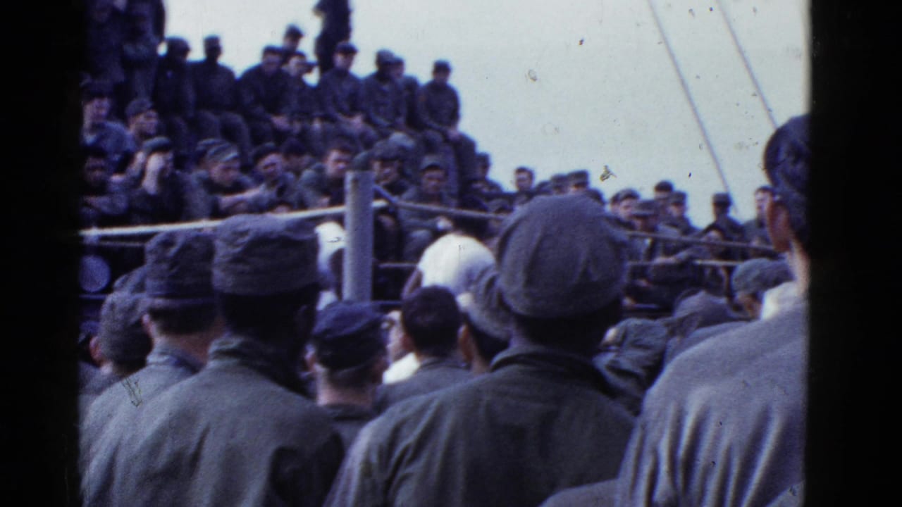 1950s 8mm frame of uniformed servicemen gathered around a roped boxing area on a vessel near San Francisco.