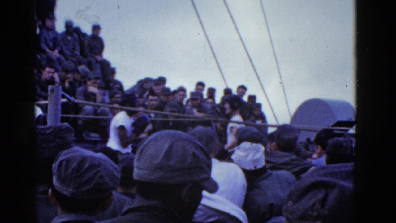 1950s home-movie view of men in caps and uniforms watching an activity from a crowded ship deck near San Francisco per metadata.