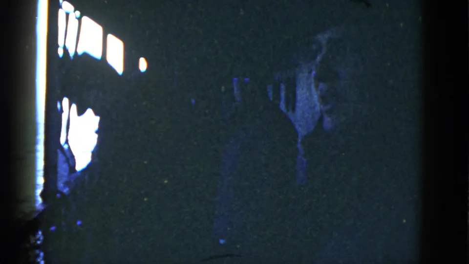 Men are partly visible in shadow inside the vessel, standing near bright windows that outline their faces and bodies.