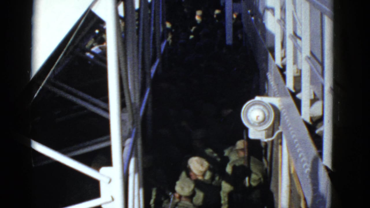 Soldiers move through a shadowed passage beside white railings.
