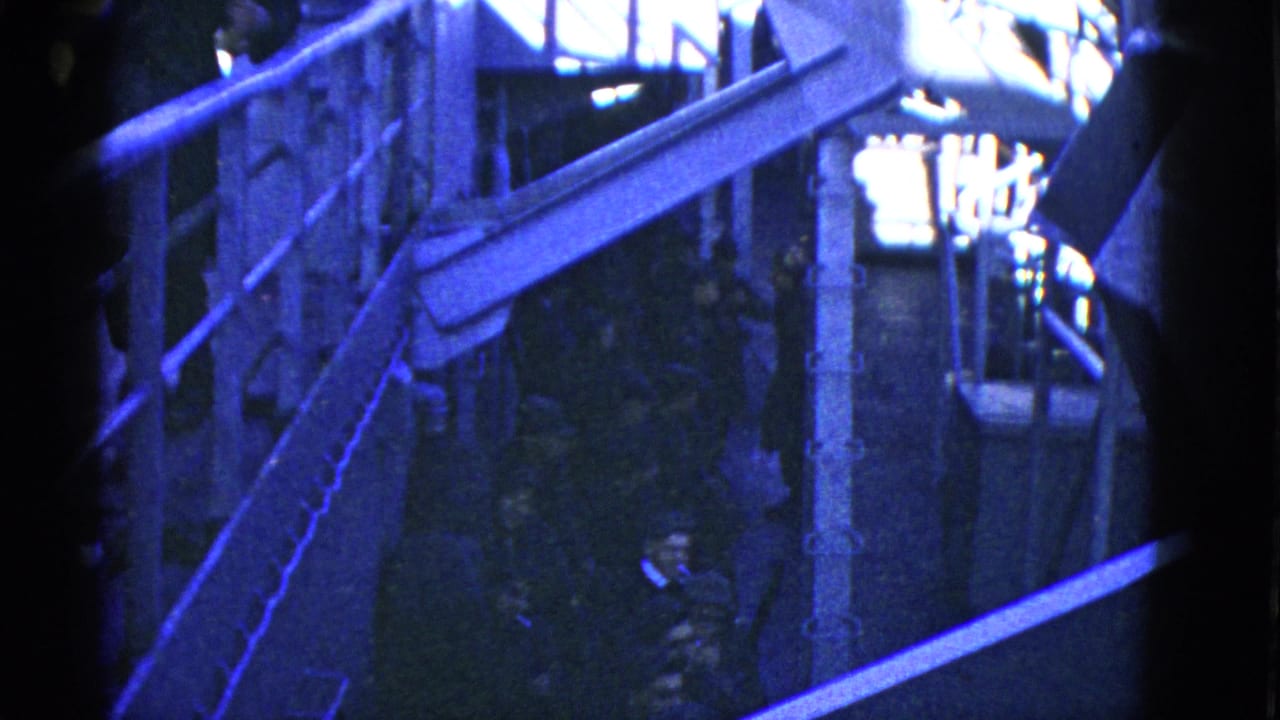 Similar dock view with railings, a raised walkway and people partly visible below.