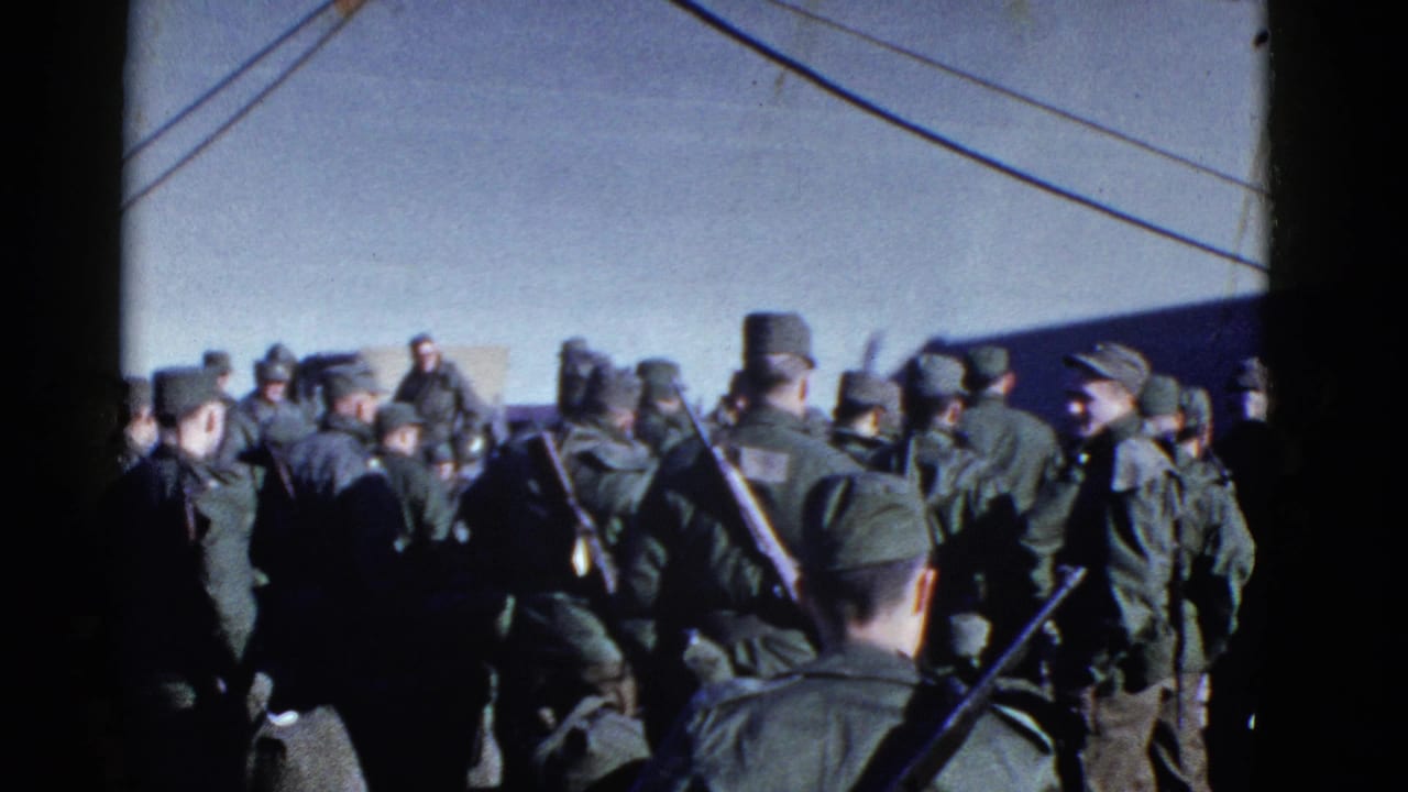 1952 San Francisco home-movie frame showing uniformed men waiting near a ship, with rigging lines overhead.